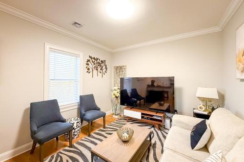a living room with a couch and a tv at 40-Newly renovated, stylish and beautiful apartment with 4br in Boston