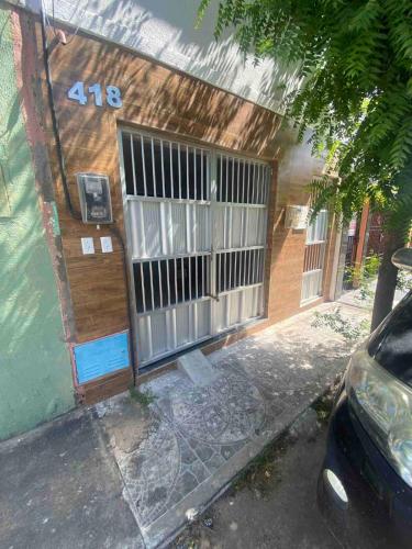 a building with a gate on the side of it at Ap no campo dos velhos com ar in Sobral