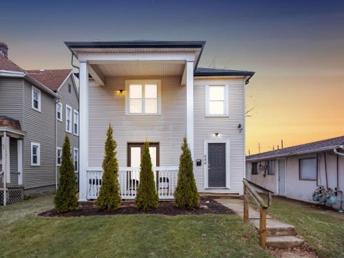 a white house with a fence in a yard at Stay in the Palazzo in OSU! 10 BEDS! in Columbus