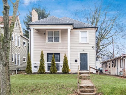 a large white house with a black door at Stay in the Palazzo in OSU! 10 BEDS! in Columbus