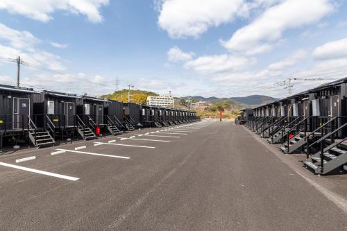 a row of train cars parked on the side of a road at HOTEL R9 The Yard Kanzaki in Kanzaki