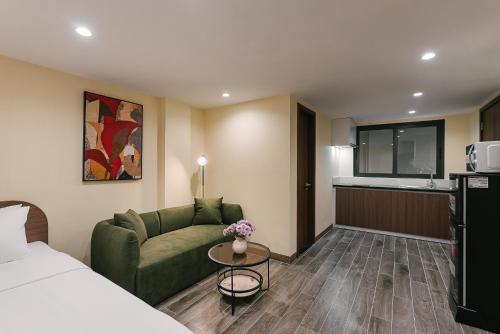 a hotel room with a bed and a couch and a table at An Nguyen Lakeside Residence in Hanoi