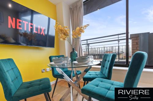 a dining room with a table and chairs and a window at Luxe Penthouse-CityCentre-Parking-Balcony in Birmingham