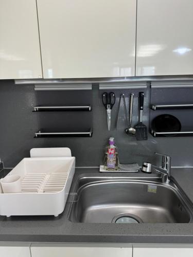 a kitchen counter with a sink and a sink at Haeundae Beach Stay Hotel in Busan