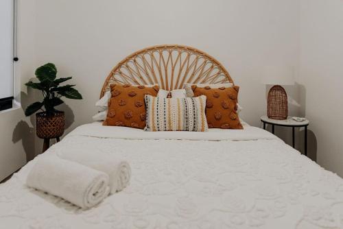 a bedroom with a large bed with pillows at Mojo's Lodge in Margaret River Town