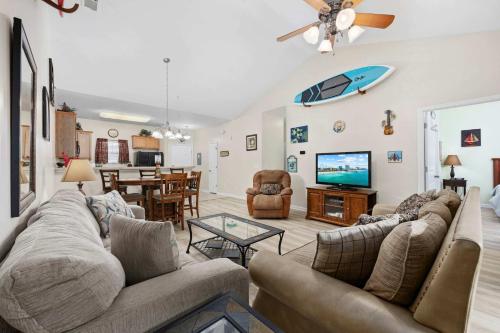 a living room with two couches and a television at Spacious 2BR Retreat with Pool Access - Barefoot in North Myrtle Beach