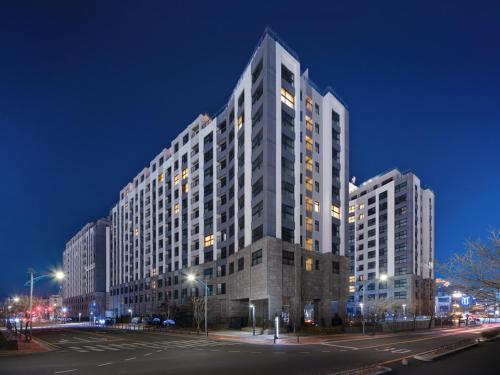 a large white building with lights on it at night at Le Collective Sokcho Central in Sokcho