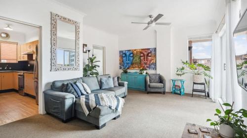a living room with a couch and a table at Beachside Oasis - Ocean Views and Walk to Everything in Wollongong