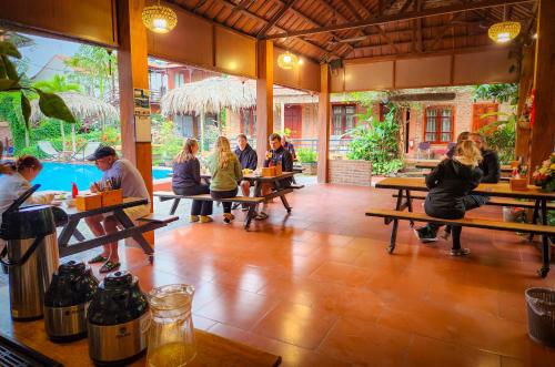 a group of people sitting at tables in a restaurant at Trang An Village Homestay in Ninh Binh