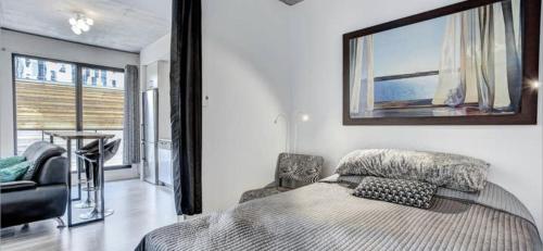 a bedroom with a bed with a picture on the wall at INCh in Montréal