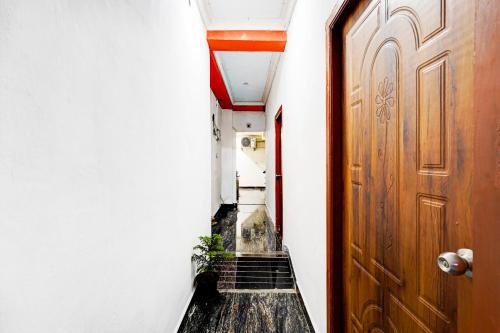a hallway with a door and a cat sitting next to it at Super Collection O Mahabalipuram in Mahabalipuram