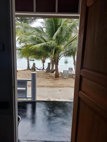 a door to a room with a view of the beach at Ella's Place Salang Tioman in Tioman Island