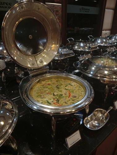 a bunch of food on a table with plates of food at Aiyaree Place Hotel SHA PLUS in Jomtien Beach