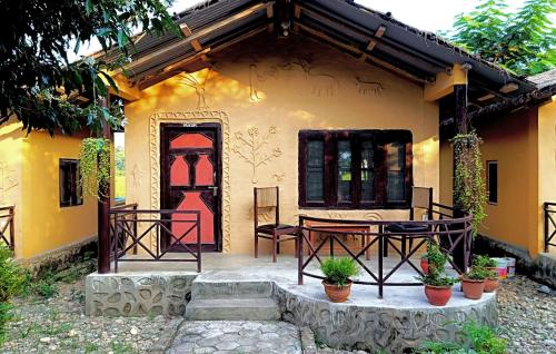 a house with a table and chairs in front of it at Nature's Way Homestay in Bhurkīā