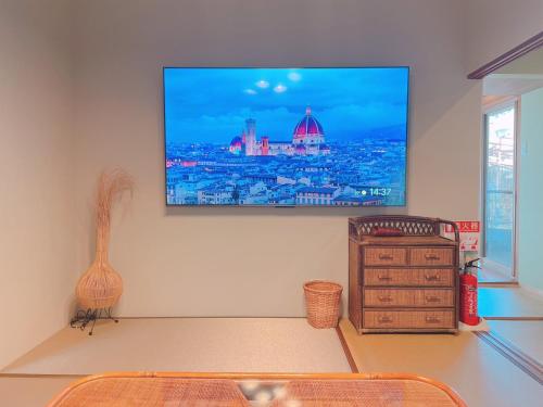 a living room with a flat screen tv on the wall at 淡路屋-Awajiya vacation home-ドッグラン付き別荘 BBQ PET OK in Awaji