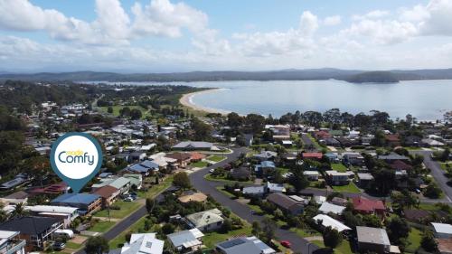 an aerial view of a town next to a body of water at Coastal Upper-Level Home with Shared Pool Access in Batehaven