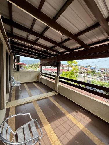 a balcony with a chair and a train station at Bamboo GuestHouse in Kuantan