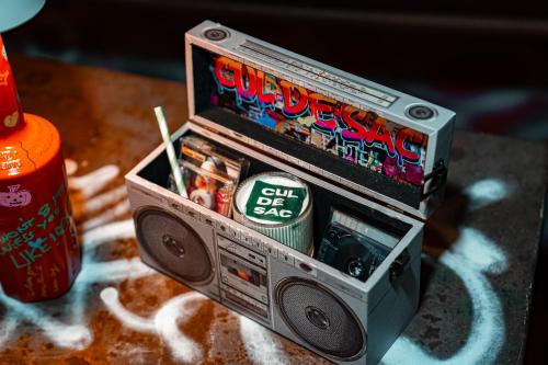 a small radio sitting on top of a table at The Quartier Hotel Phromphong - Thonglor in Bangkok