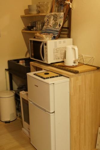 a microwave sitting on top of a counter at yohaku in Matsue