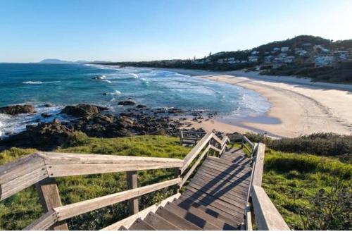 a boardwalk leading to a beach with the ocean at Port Macquarie Ocean Escape in Port Macquarie