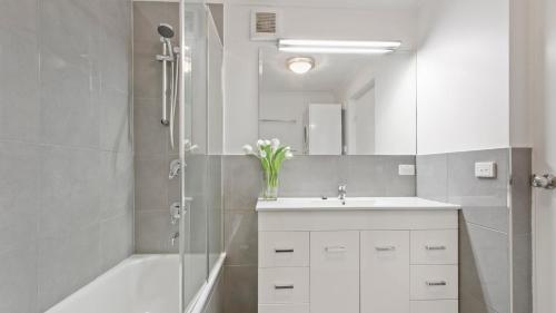 a bathroom with a white sink and a shower at Lawlers 30 in Mount Hotham