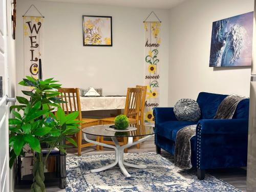 a living room with a blue couch and a table at Global Family Canada in Calgary