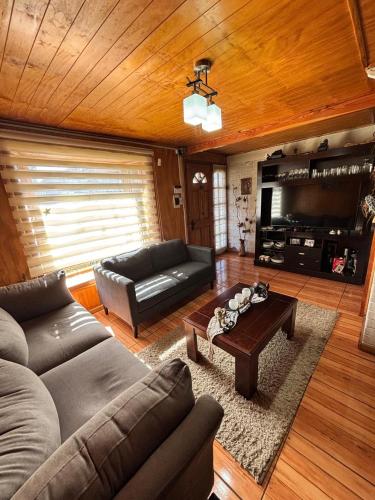 a living room with a couch and a coffee table at hospedaje mi casa in La Unión