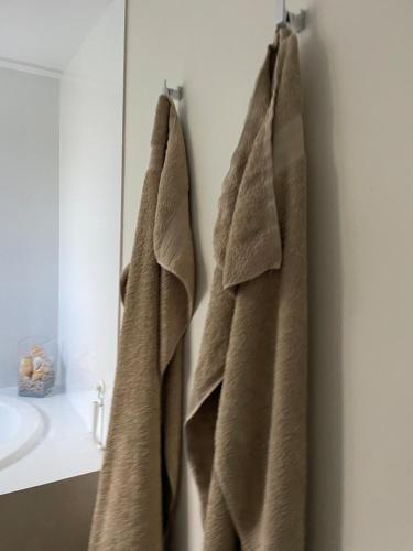 a bathroom with two towels hanging on a wall at Unique Australian Shed Style House in Dunsborough