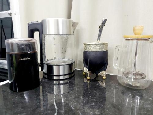 a counter with a blender and other appliances on it at The Nomad Hostel in Alajuela City