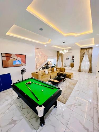 a living room with a pool table in it at Home away from Home in Lekki