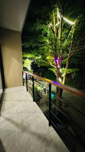 a balcony with a view of a tree at night at GM Apartments 2 Bedrooms in Amphoe Koh Samui