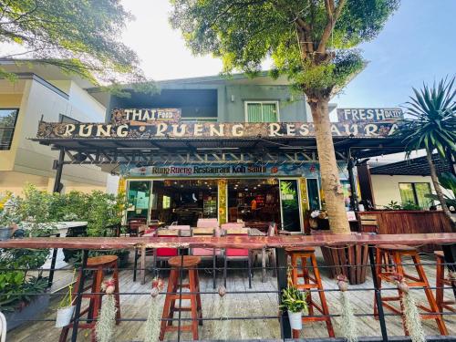 a restaurant with a table and chairs in front of it at GM Apartments 2 Bedrooms in Amphoe Koh Samui