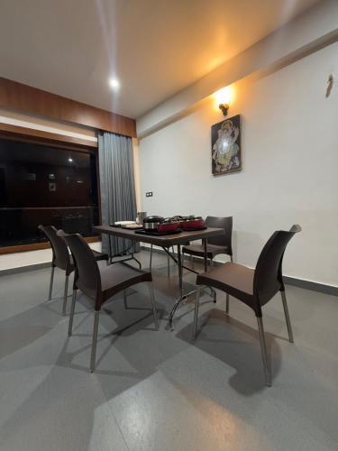 a dining room with a table and chairs at Satyam Shivam Sundaram in Mukteswar