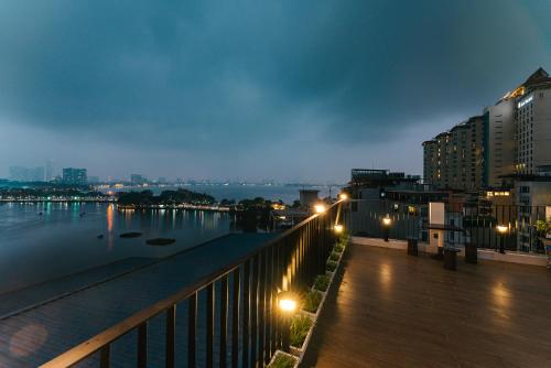a view of a river at night with buildings at An Nguyen Lakeside Residence in Hanoi