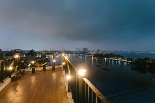 a view of a river at night with street lights at An Nguyen Lakeside Residence in Hanoi