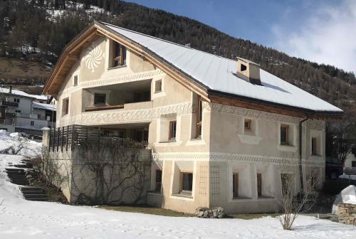 a house is being built in the snow at Apartment for 1-4 people Chasa Plazzöl in Müstair
