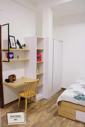 a bedroom with a bed and a desk and a bed and a chair at FlexiHome in Ho Chi Minh City