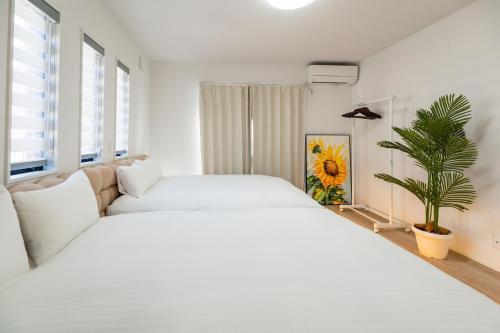 Ένα ή περισσότερα κρεβάτια σε δωμάτιο στο Fuji Holiday C