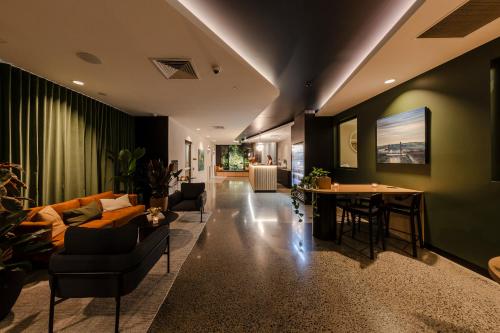 a living room with a couch and a table at Sage Hotel James Street in Brisbane