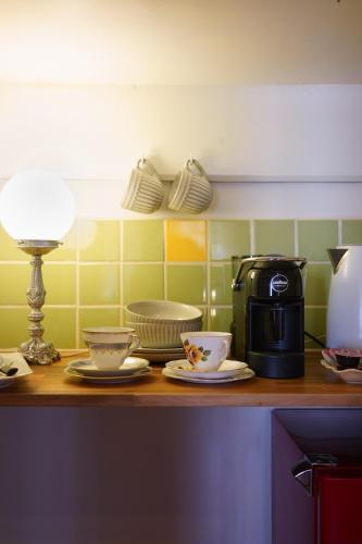 a kitchen with a counter with plates and a coffee maker at Bank-sia accommodation in Mount Barker