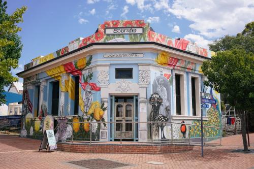 a building with paintings on it on a street at Bank-sia accommodation in Mount Barker