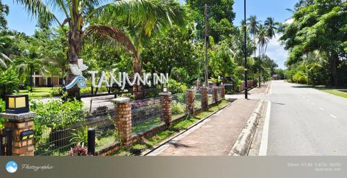 a street with a fence and a sign that reads terminal at Tanjung Inn in Kuantan