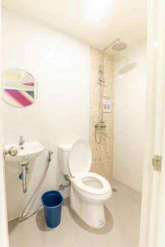 a bathroom with a toilet and a sink at Astrotel Cebu in Cebu City