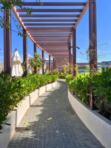a walkway with potted plants in a building at Apec Mandala Wyndham Mui Ne by HK S0624 in Ấp Thiẹn Ái