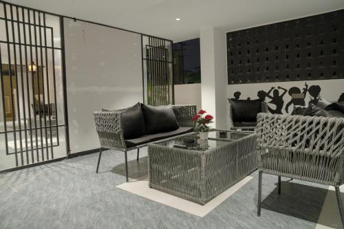 a living room with two chairs and a table at HOTEl EUPHORIA AIRPORT Zone in Hyderabad