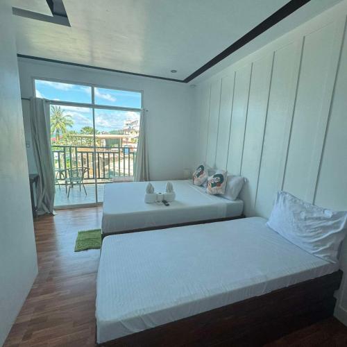 Katil atau katil-katil dalam bilik di MANANQUIL TRAVEL LODGE