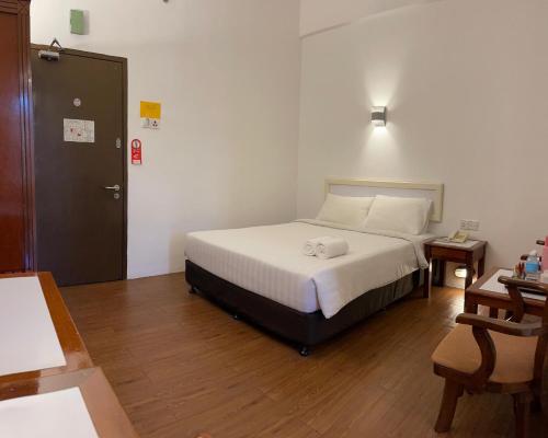 Postel nebo postele na pokoji v ubytování Hotel Ipoh City