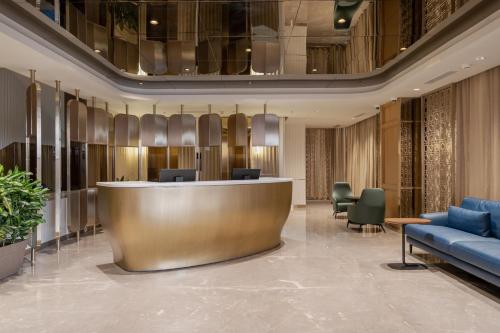 a lobby with a reception desk in a building at The Magnus in Coimbatore