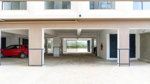 a garage with a red car parked in it at Delight stays in Ongata Rongai 