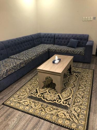 a living room with a couch and a coffee table at العنوان للشقق المخدومة ALanwaan of the units served in Dammam